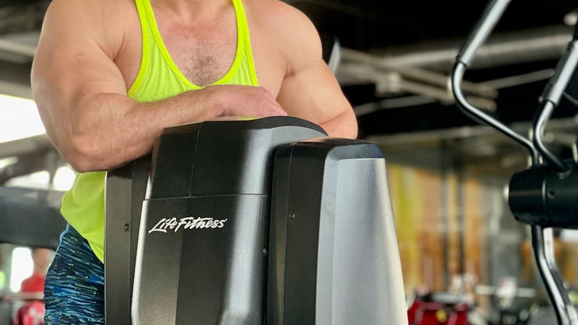 Man focused on a physical exercise in a modern gym.