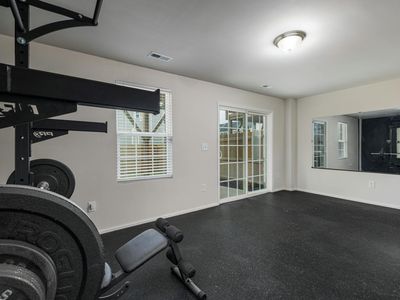Wide view of a clean minimalist home gym setup.